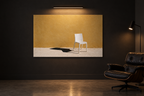 Empty Chair print on a dark gallery wall under a picture light