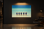 Formation print on a dark gallery wall under a picture light