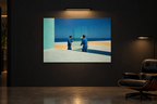 Glass print on a dark gallery wall under a picture light