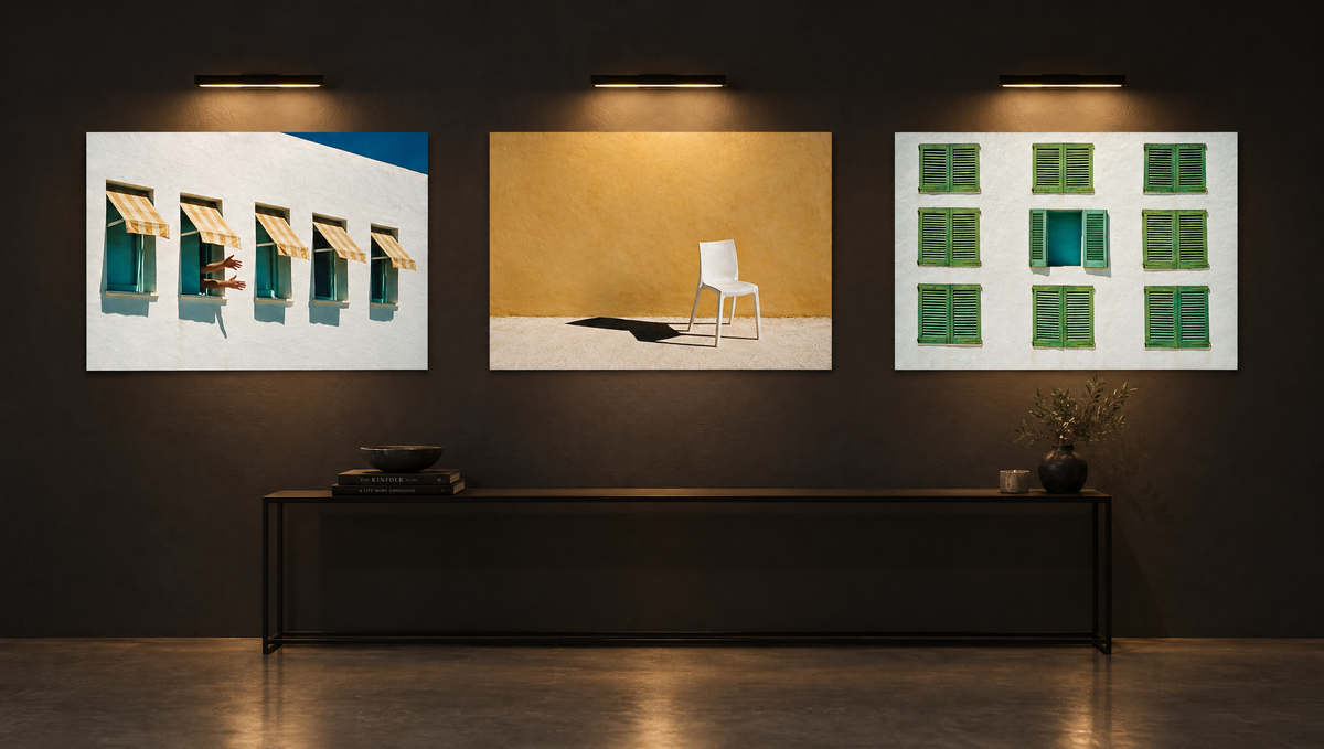 Three High Noon prints hung together on a dark gallery wall — Awning, Empty Chair and Blinds